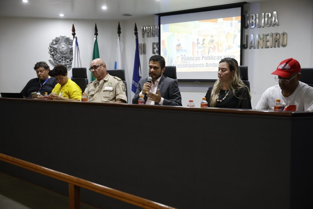 caseiro explorado: Seis pessoas em mesa de audiência pública do Ministério Público Federal discutindo direitos sociais.