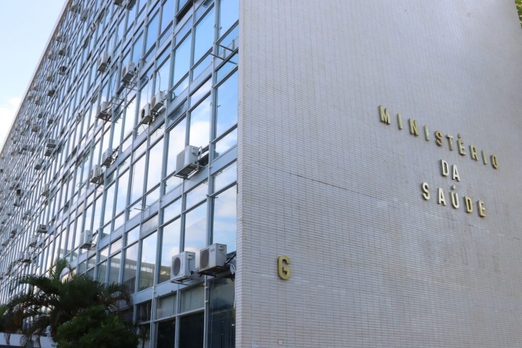 assistência social e saúde: fachada do prédio do Ministério da Saúde com letras douradas em parede branca e vidros.