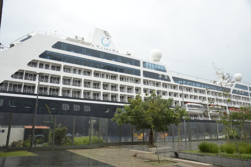 temporada de cruzeiros: navio da empresa Azamara atracado em porto sob céu nublado.